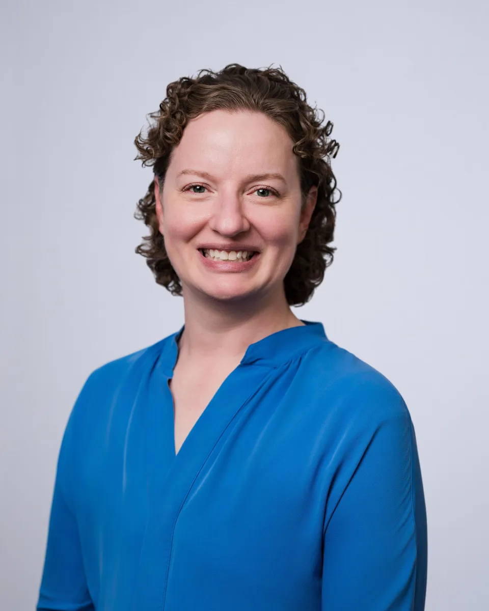 Portrait of Dr. Shannon Foster, smiling, in a blue blouse